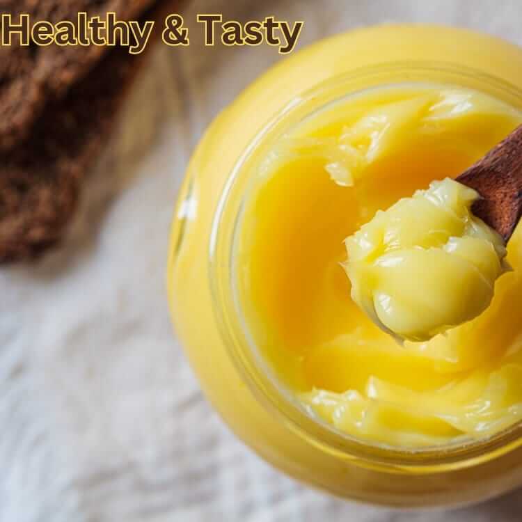 Himalayan Badri Cow Ghee in a jar with a wooden spoon, showcasing its rich texture and golden color.