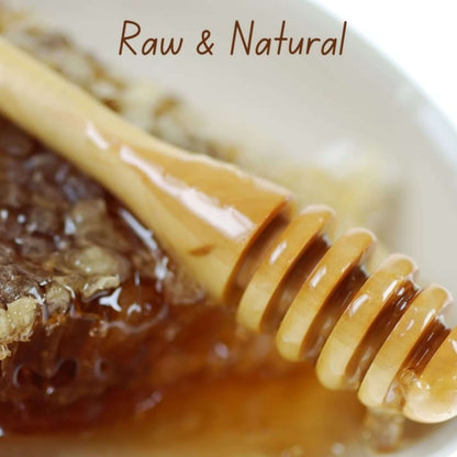 Himalayan Jamun Flower Raw Honey being drizzled from a honey dipper, highlighting its raw and natural qualities.