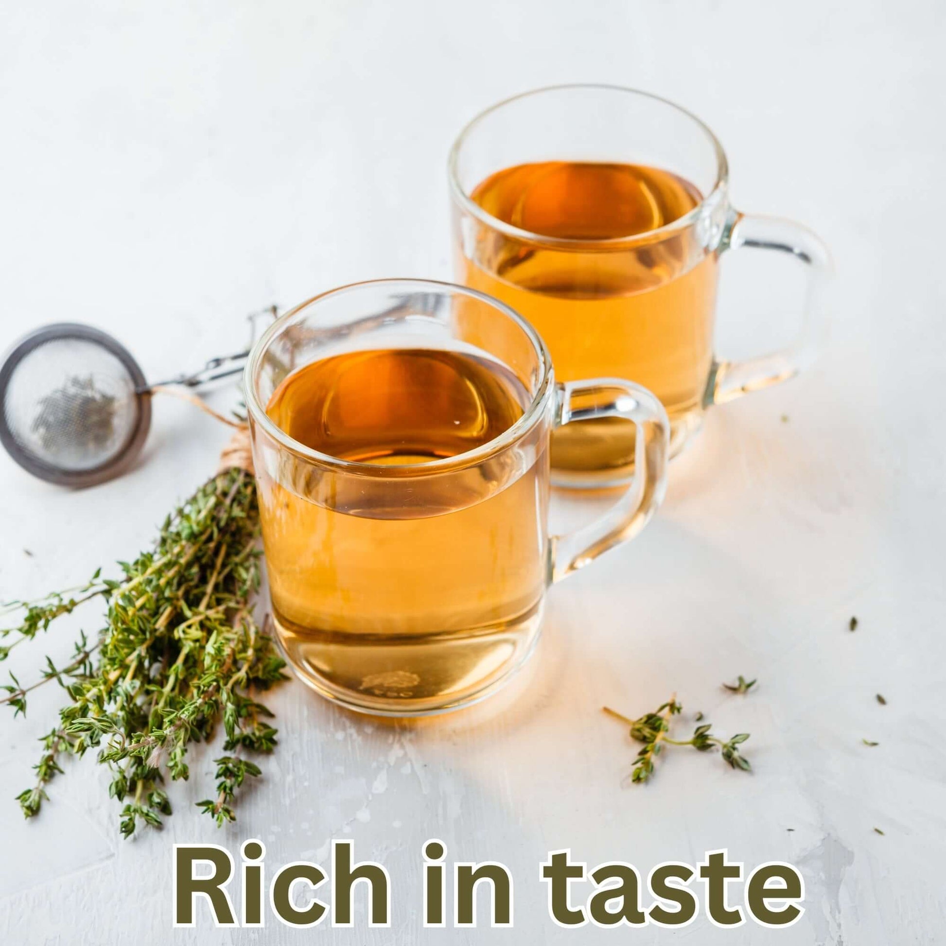 Himalayan raspberry leaf green tea in transparent mugs with loose leaf thyme on the side.